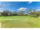 Scenic view of a golf course putting green with trees and sky at 5304 96Th E St, Bradenton, FL 34211