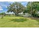 Scenic golf course view with lush green, trees, and tranquil waterside scenery under a partly cloudy sky at 5304 96Th E St, Bradenton, FL 34211