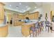 Open-concept kitchen featuring custom cabinetry, a breakfast bar, and modern appliances, perfect for culinary enthusiasts at 5304 96Th E St, Bradenton, FL 34211