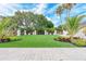 Well-manicured lawn overlooking common area with plenty of seating, manicured plants and trees at 5304 96Th E St, Bradenton, FL 34211