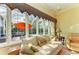 Bright living room featuring a large window with an outdoor view of the screened-in pool at 5304 96Th E St, Bradenton, FL 34211