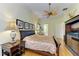 Well-lit bedroom features wood floors, ceiling fan, and neutral wall color at 5304 96Th E St, Bradenton, FL 34211