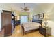 Bright bedroom with wood flooring, large bed, and neutral decor at 5304 96Th E St, Bradenton, FL 34211