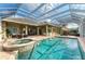 An impressive screened-in pool area features a hot tub, patio, and outdoor bar at 5304 96Th E St, Bradenton, FL 34211