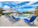 Community pool and patio with plenty of seating and umbrellas at 5304 96Th E St, Bradenton, FL 34211