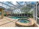 Inviting screened-in pool and hot tub with brick paver deck at 5304 96Th E St, Bradenton, FL 34211