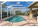 Inviting screened-in pool and spa surrounded by lush landscaping at 5304 96Th E St, Bradenton, FL 34211