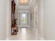 Bright and airy foyer with tile flooring and a large mirror at 5361 Salcano St, Sarasota, FL 34238