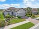 One-story home with tile roof, gray siding, and a paved driveway at 5361 Salcano St, Sarasota, FL 34238