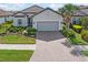 Single-story home with gray garage door and landscaped yard at 5361 Salcano St, Sarasota, FL 34238