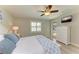 Bedroom features a ceiling fan, mounted television, and sliding glass door access to the pool at 5551 Allamanda Ave, North Port, FL 34288