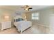 Cozy bedroom with crown molding, ceiling fan, window with shutters, and coastal decor at 5551 Allamanda Ave, North Port, FL 34288