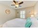 Bedroom featuring a queen bed, ceiling fan, and neutral walls at 5551 Allamanda Ave, North Port, FL 34288