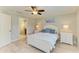 Bedroom featuring a ceiling fan, walk-in closet, and coastal decor at 5551 Allamanda Ave, North Port, FL 34288