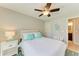 Bedroom with a queen bed, ceiling fan, and an ensuite bathroom at 5551 Allamanda Ave, North Port, FL 34288