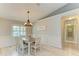 Cozy dining room featuring natural light, a modern light fixture, and neutral decor at 5551 Allamanda Ave, North Port, FL 34288