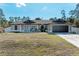 Charming single-story home with a well-manicured lawn, two-car garage and welcoming front entrance at 5551 Allamanda Ave, North Port, FL 34288