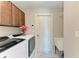 Laundry room with modern washer/dryer, sink, and overhead cabinet at 5551 Allamanda Ave, North Port, FL 34288