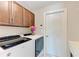 Laundry room with modern washer/dryer, and overhead cabinet at 5551 Allamanda Ave, North Port, FL 34288