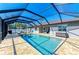 Beautiful pool and screened-in enclosure with ample seating and a tidy outdoor space, perfect for relaxation at 5551 Allamanda Ave, North Port, FL 34288