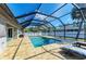 Screened-in pool and patio area with relaxing lounge chairs provide a perfect space for outdoor living and recreation at 5551 Allamanda Ave, North Port, FL 34288