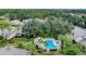 Aerial view of a pool surrounded by tropical landscaping at 5653 Pipers Waite # 26, Sarasota, FL 34235