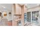 Elegant kitchenette area featuring built-in appliances, granite countertop, and access to the patio at 5653 Pipers Waite # 26, Sarasota, FL 34235