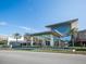 Modern mall exterior with glass facade and palm trees welcomes shoppers to a vibrant retail experience at 5653 Pipers Waite # 26, Sarasota, FL 34235