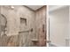 Modern shower with marble-like tiling, glass door, and updated fixtures, including a rainfall showerhead at 5653 Pipers Waite # 26, Sarasota, FL 34235