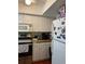 Galley kitchen with white cabinets and stainless steel appliances at 6067 Arlene Way, Bradenton, FL 34207