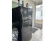 Black refrigerator located in the screened porch area at 6067 Arlene Way, Bradenton, FL 34207