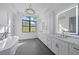 Luxurious bathroom with double vanity and soaking tub at 656 Tropical Cir, Sarasota, FL 34242