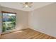 Spacious bedroom with wood floors and large window at 6947 Woodwind Dr # 77, Sarasota, FL 34231