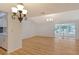 Bright dining room with wood floors and sliding glass doors at 6947 Woodwind Dr # 77, Sarasota, FL 34231