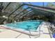 Refreshing community pool with screened enclosure at 6947 Woodwind Dr # 77, Sarasota, FL 34231