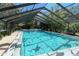 Community pool under a screened enclosure at 6947 Woodwind Dr # 77, Sarasota, FL 34231