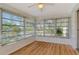 Sunroom features light flooring, multiple windows, and a ceiling fan at 6947 Woodwind Dr # 77, Sarasota, FL 34231