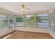 Sunroom with wood flooring and multiple windows at 6947 Woodwind Dr # 77, Sarasota, FL 34231