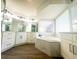 Elegant bathroom with white cabinets, soaking tub, and modern fixtures at 7724 Us Open Loop, Lakewood Ranch, FL 34202