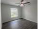 Bright bedroom with ceiling fan and gray flooring at 7724 Us Open Loop, Lakewood Ranch, FL 34202