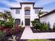 Front view of a two-story house with a walkway and manicured landscaping at 7724 Us Open Loop, Lakewood Ranch, FL 34202