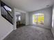 Spacious living room with grey carpet and large windows at 7724 Us Open Loop, Lakewood Ranch, FL 34202