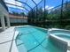 Inviting screened pool and spa with a spacious deck at 7724 Us Open Loop, Lakewood Ranch, FL 34202