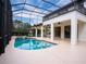 Relaxing pool and spa with covered patio and lush landscaping at 7724 Us Open Loop, Lakewood Ranch, FL 34202