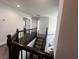 Upstairs hallway with dark wood railings and carpeted stairs at 7724 Us Open Loop, Lakewood Ranch, FL 34202