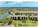 Expansive aerial view of the condo community with lush landscaping, golf course and scenic lakes at 8403 Grand Estuary Trl # 301, Bradenton, FL 34212