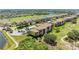 Scenic aerial view of condo community with lush landscaping, golf course, lakes, and well-maintained buildings at 8403 Grand Estuary Trl # 301, Bradenton, FL 34212