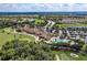 An elevated view featuring the pool, clubhouse, and golf course amenities within a beautiful landscape at 8403 Grand Estuary Trl # 301, Bradenton, FL 34212