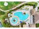 Aerial view of community pool and hot tub with golf course in the background at 8403 Grand Estuary Trl # 301, Bradenton, FL 34212