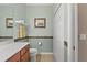 Bathroom with wood cabinets, a white countertop, and tile accents at 8403 Grand Estuary Trl # 301, Bradenton, FL 34212